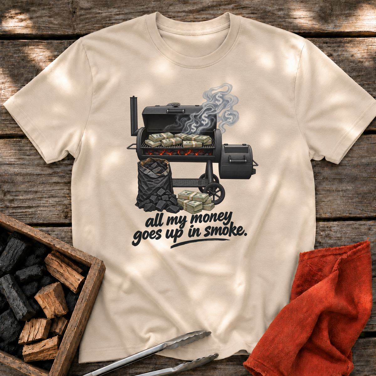 Sand T-shirt with the design “all my money goes up in smoke.” printed on the front.