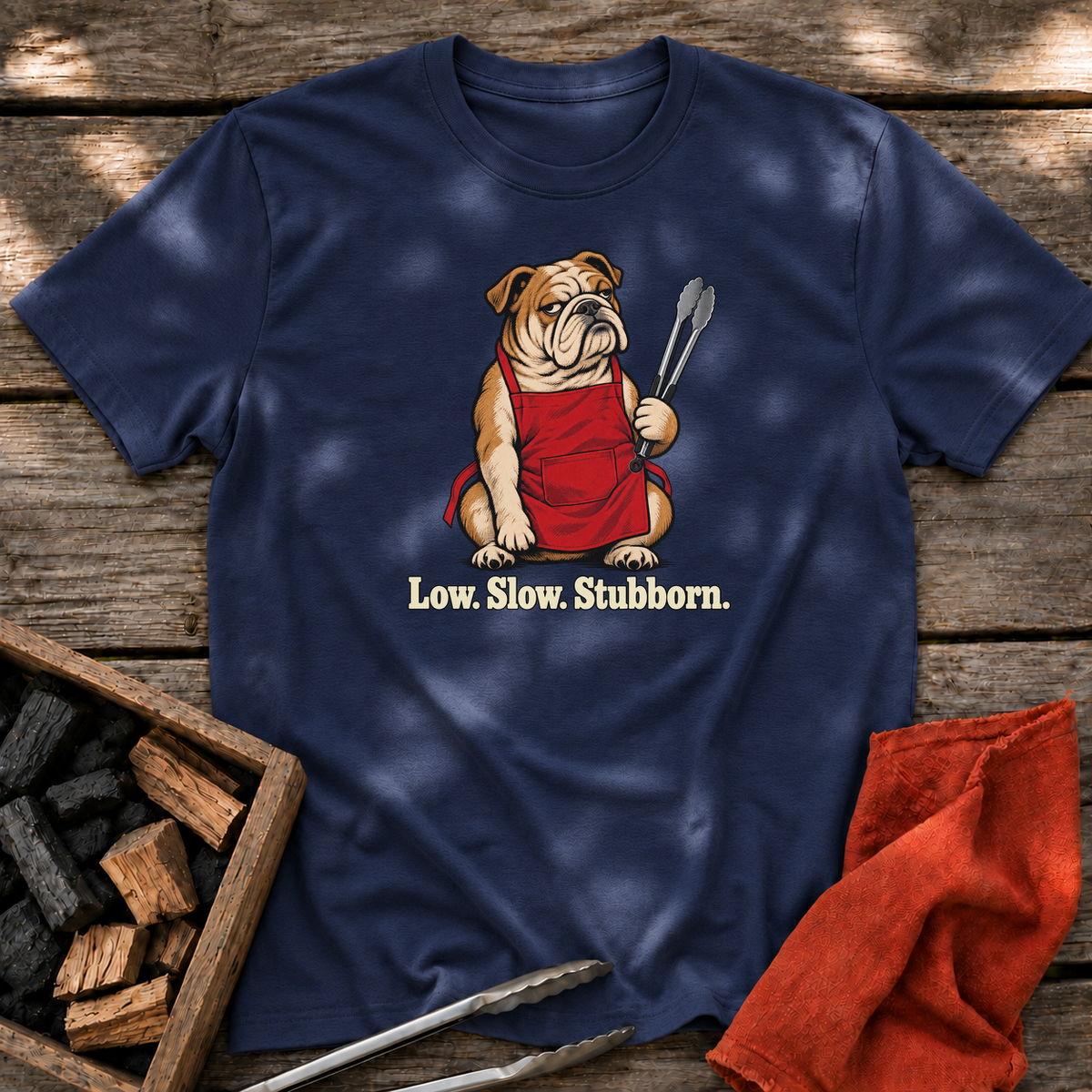Navy T-shirt with the design “Low. Slow. Stubborn.” printed on the front.