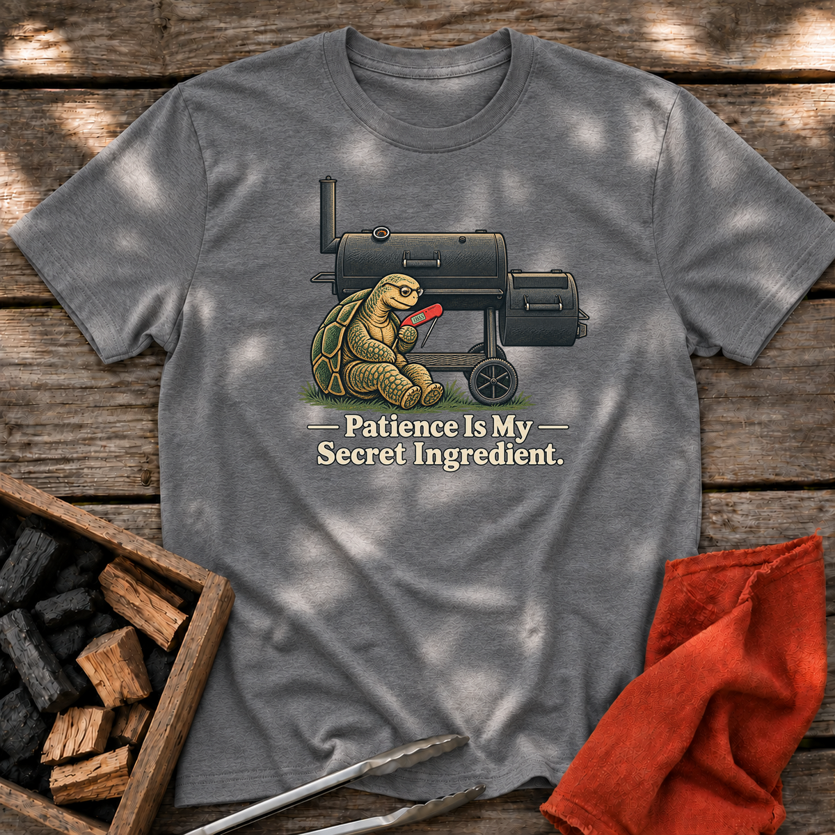 Graphite Heather T-shirt with the design “Patience Is My Secret Ingredient.” printed on the front.