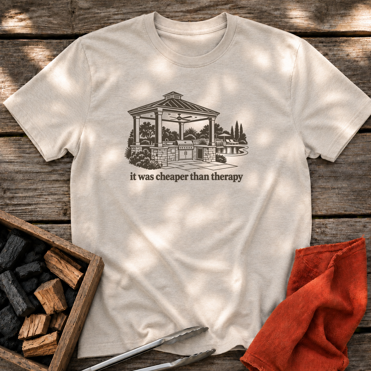 Natural T-shirt with the design “it was cheaper than therapy” printed on the front.