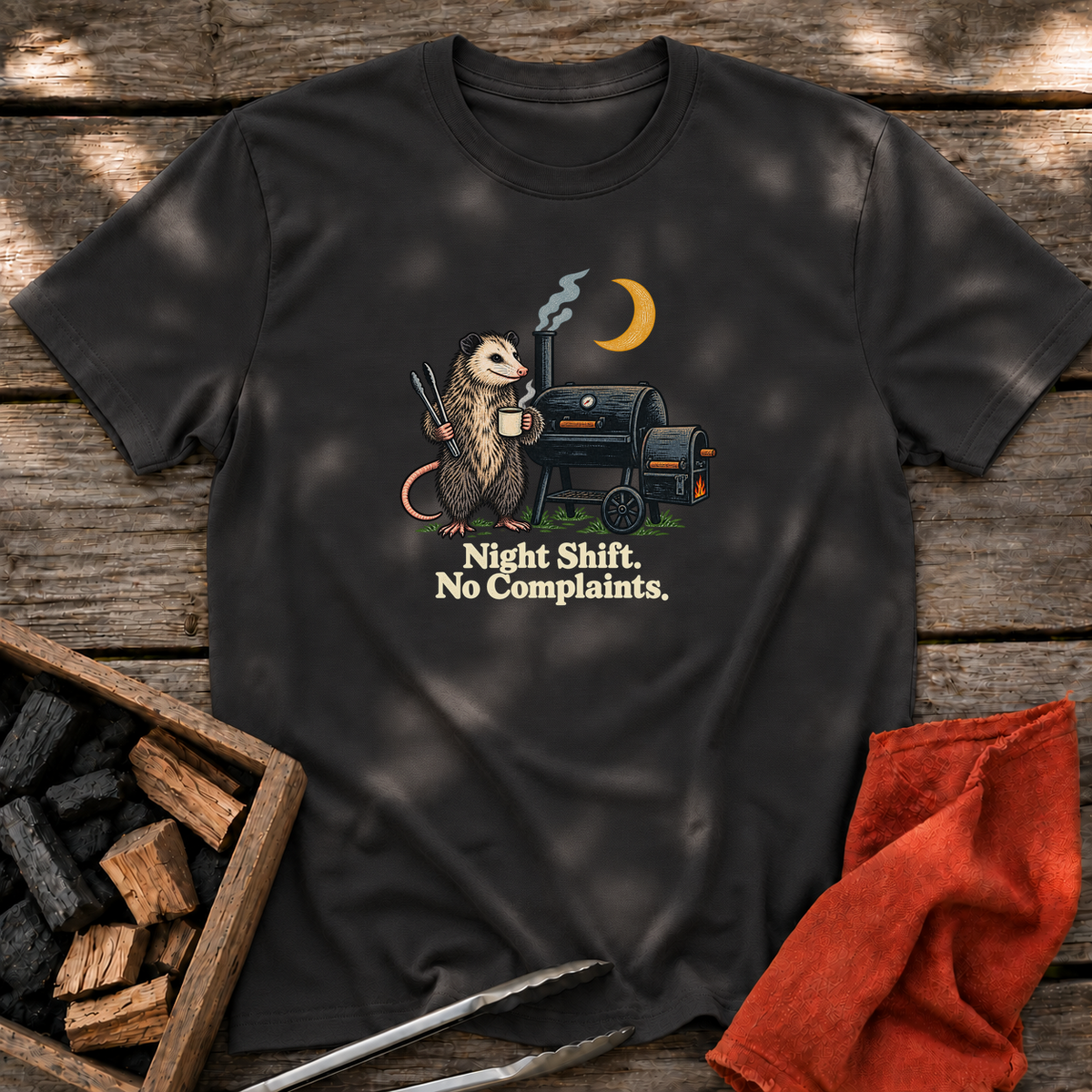 Black T-shirt with the design “Night Shift. No Complaints.” printed on the front.