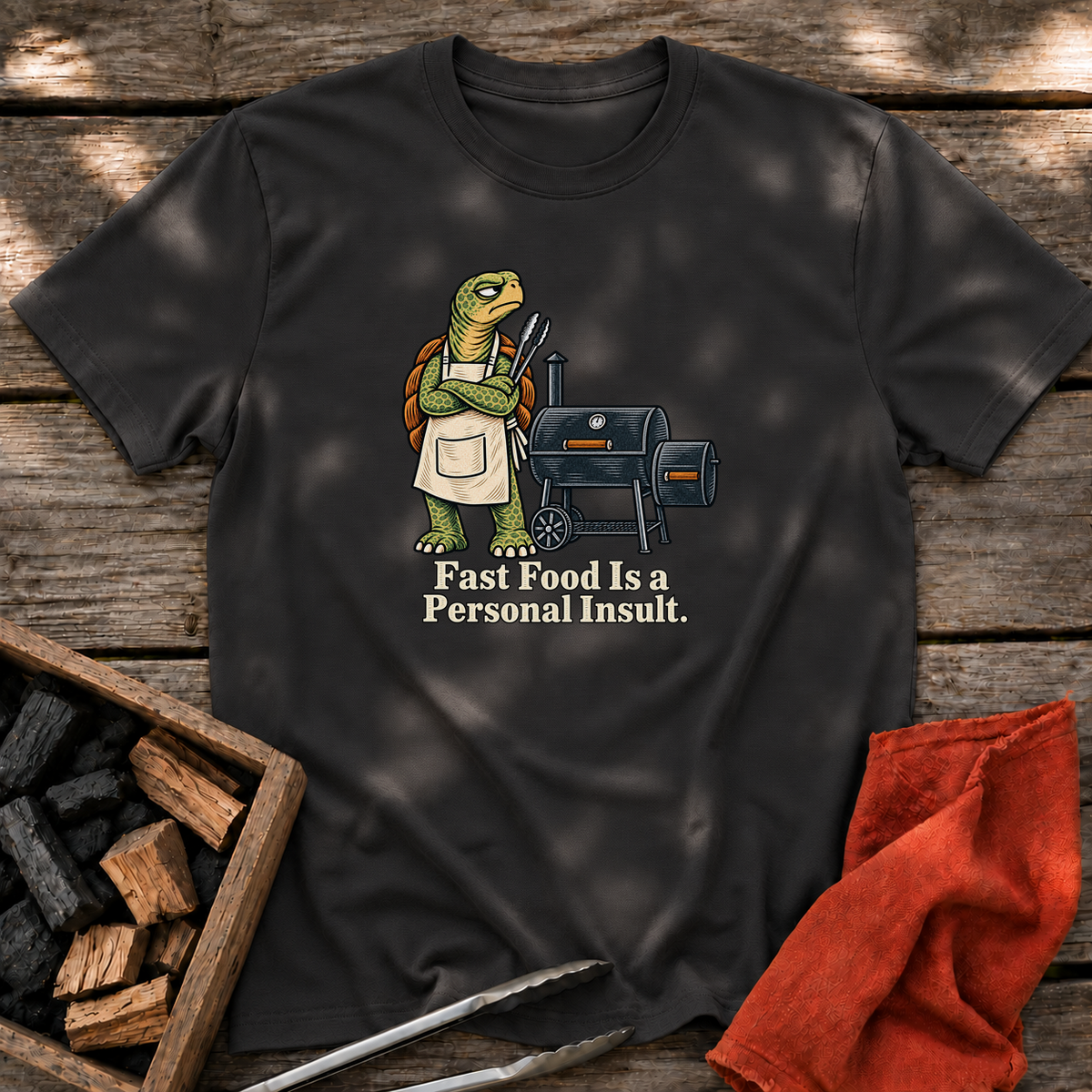 Black T-shirt with the design “Fast Food Is a Personal Insult.” printed on the front.