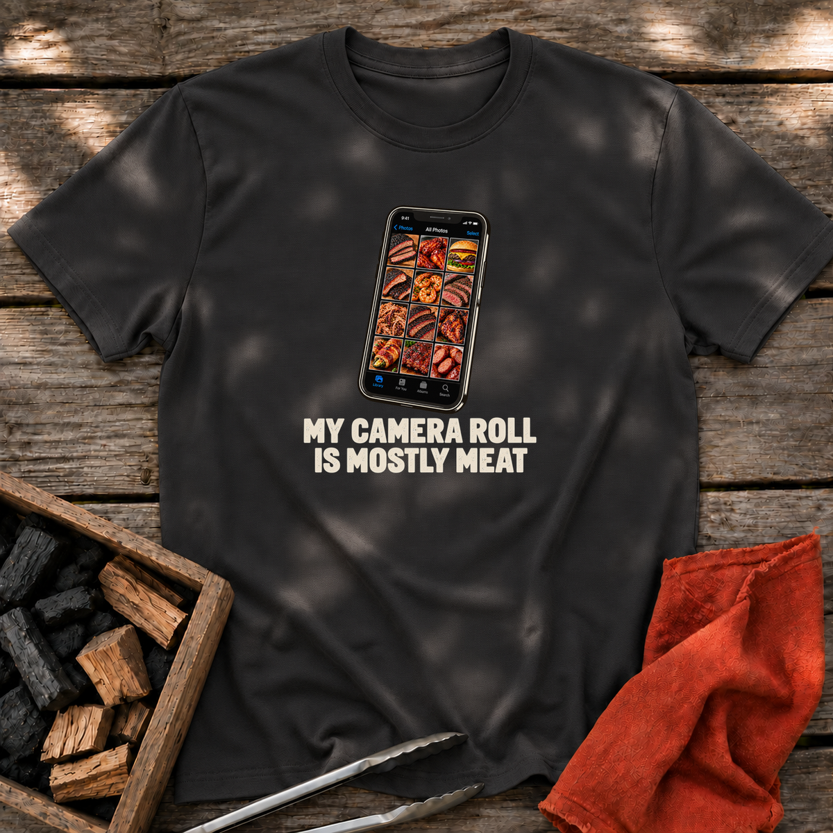 Black T-shirt with the design “MY CAMERA ROLL IS MOSTLY MEAT” printed on the front.