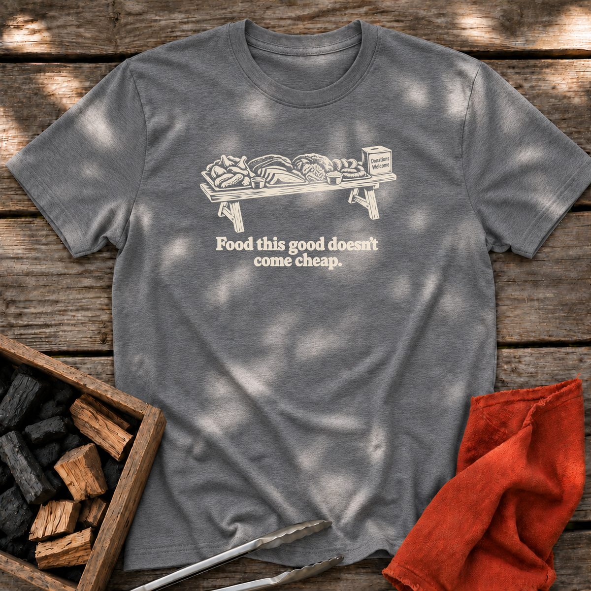 Graphite Heather T-shirt with the design “Food this good doesn’t come cheap.” printed on the front.