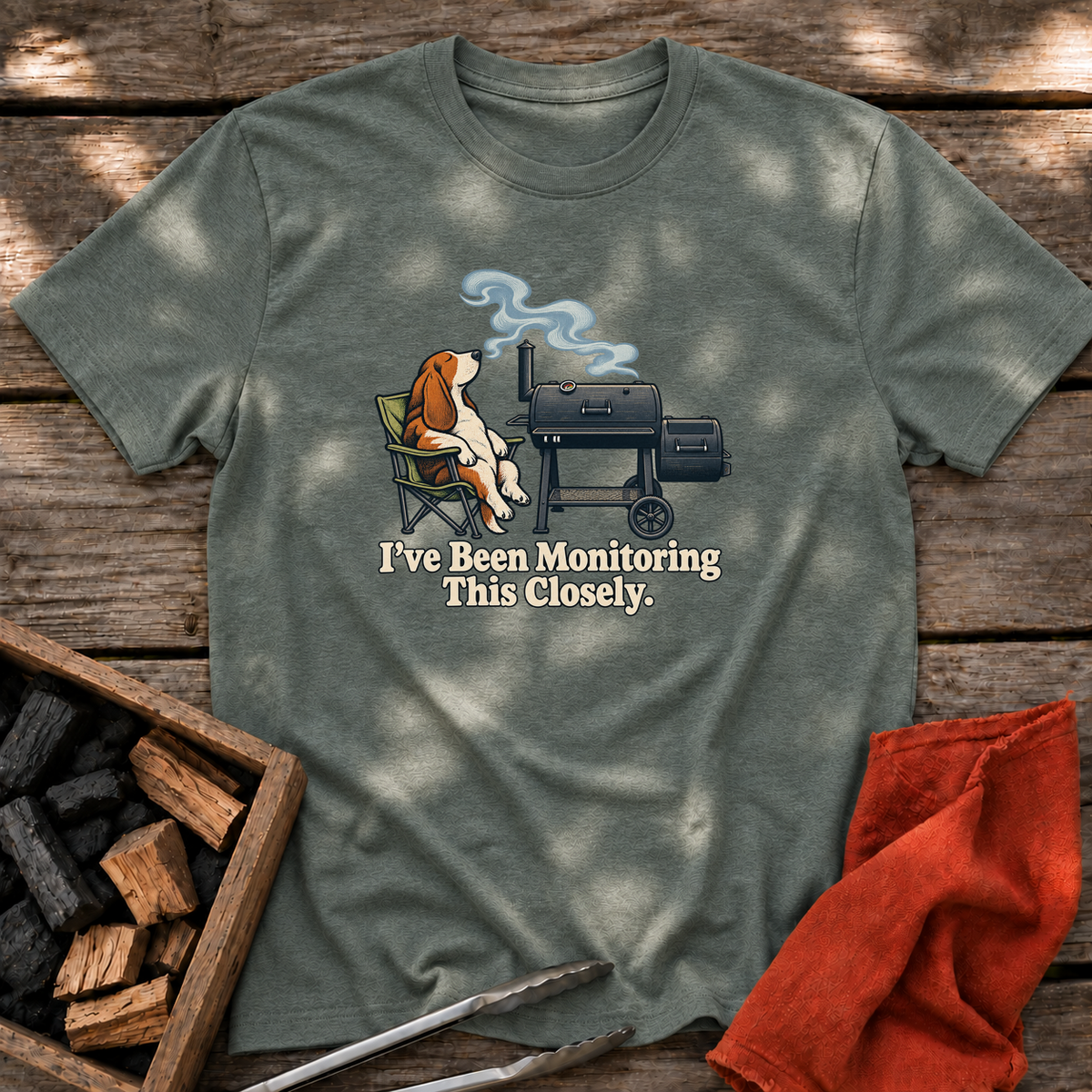 Heather Military Green T-shirt with the design “I've Been Monitoring This Closely.” printed on the front.