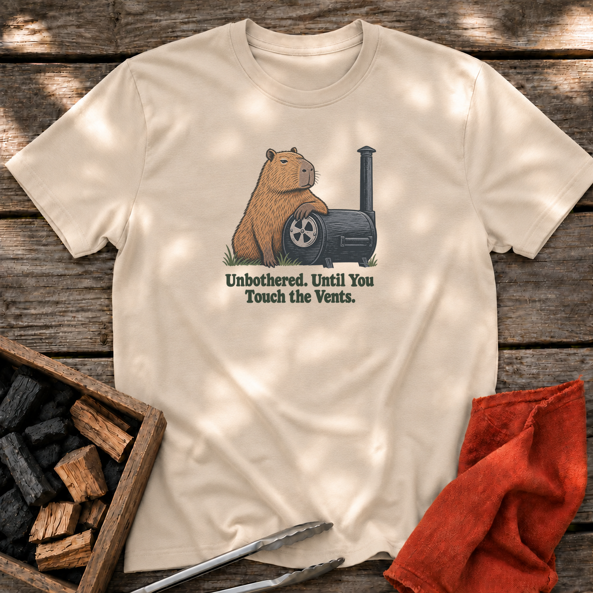 Sand T-shirt with the design “Unbothered. Until You Touch the Vents.” printed on the front.