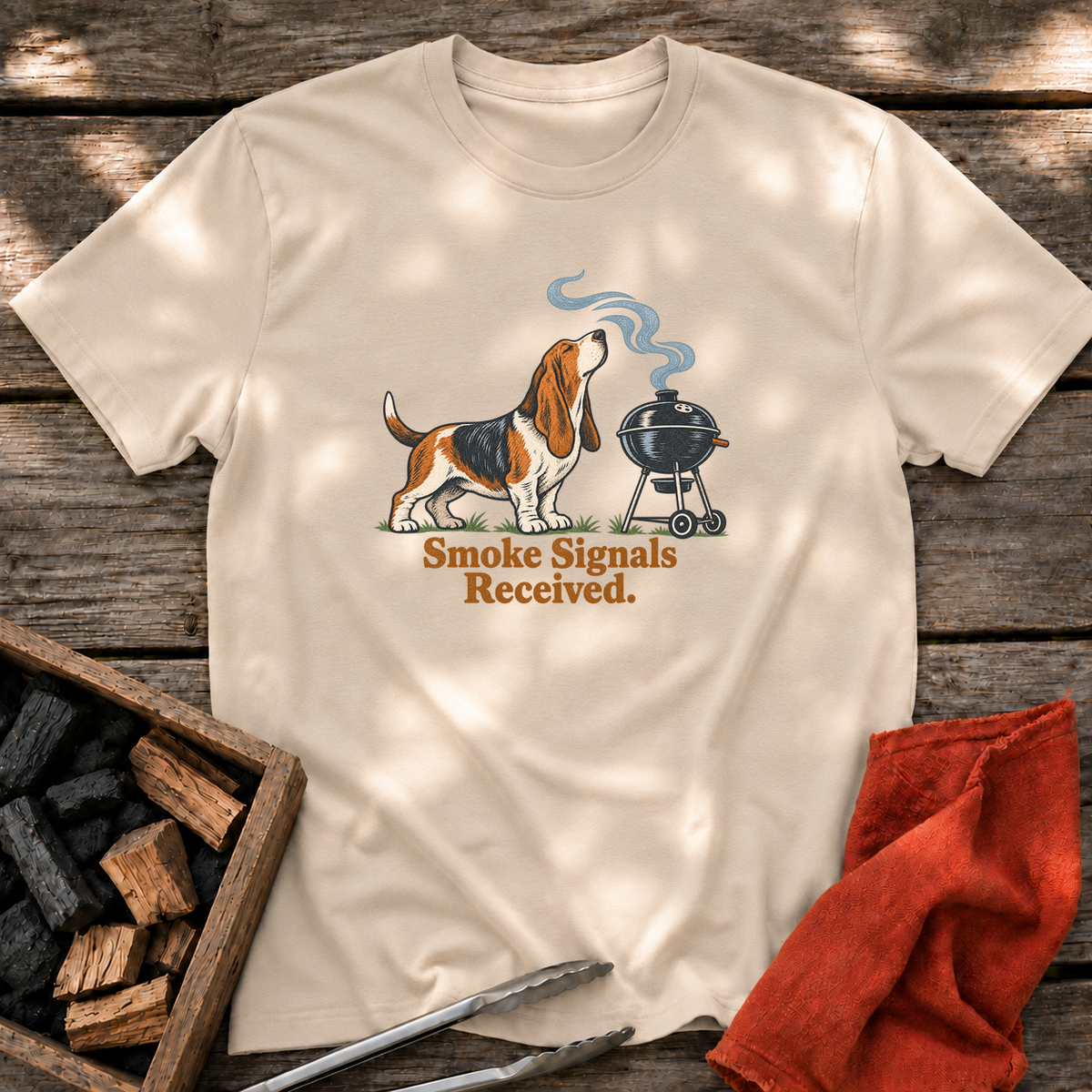Sand T-shirt with the design “Smoke Signals Received.” printed on the front.