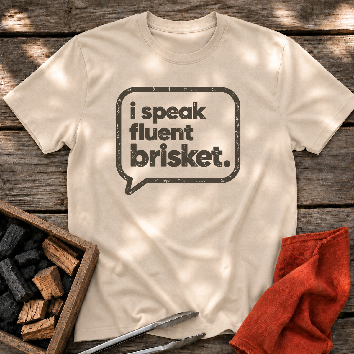 Sand T-shirt with the design “I Speak Fluent Brisket” printed on the front.