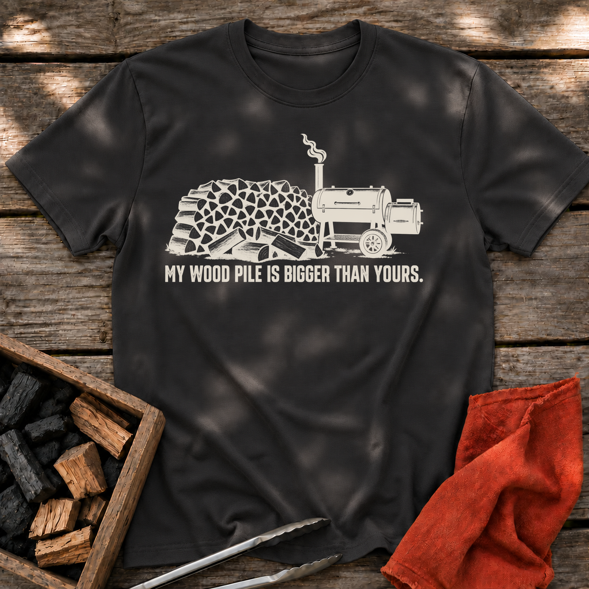 Black T-shirt with the design “My Wood Pile is Bigger Than Yours” printed on the front.