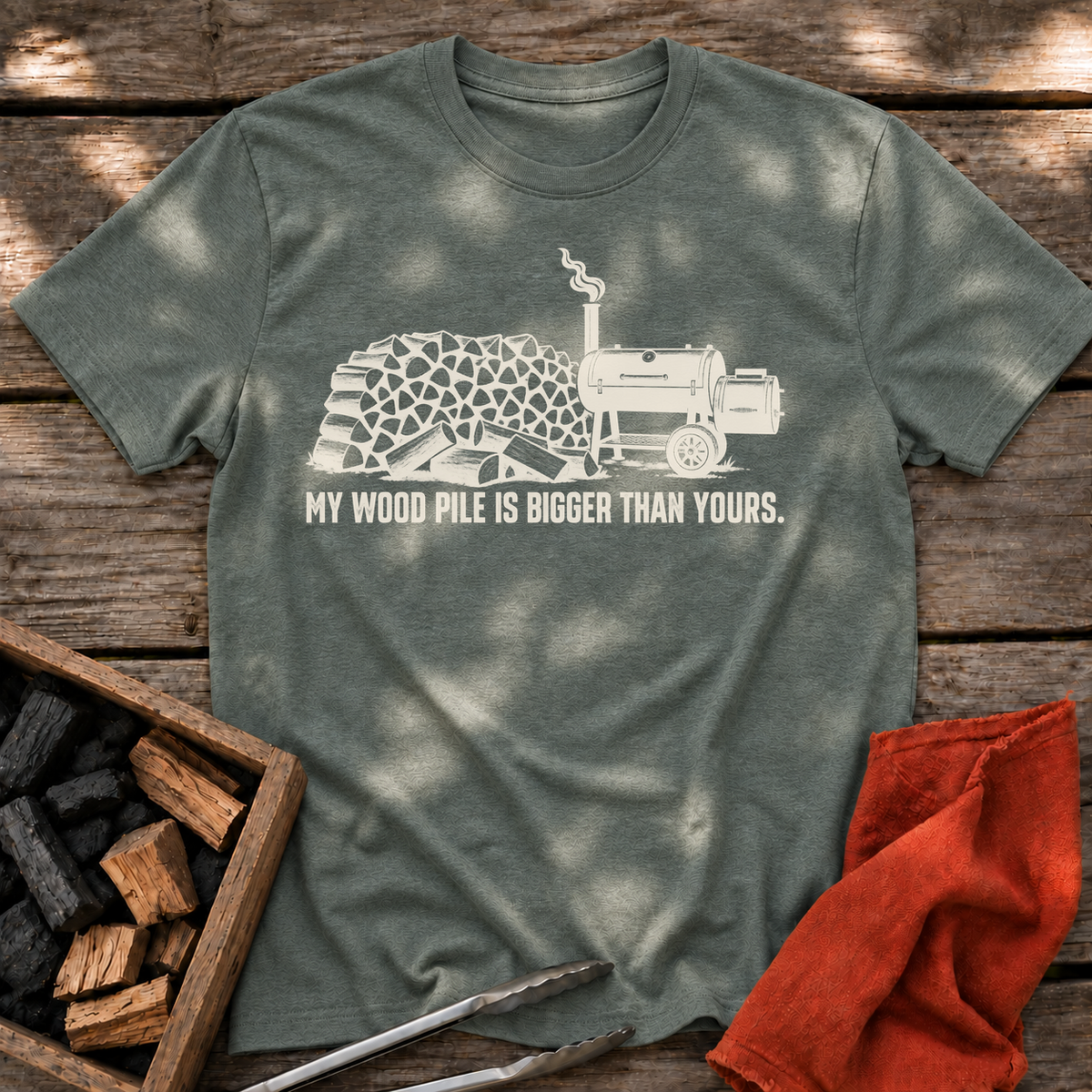 Heather Military Green T-shirt with the design “My Wood Pile is Bigger Than Yours” printed on the front.