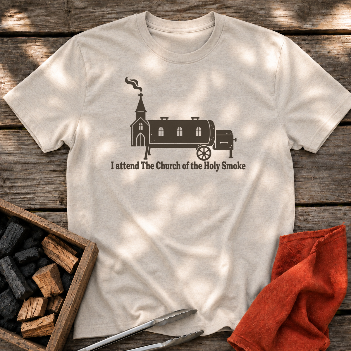 Natural T-shirt with the design “I attend The Church of the Holy Smoke” printed on the front.