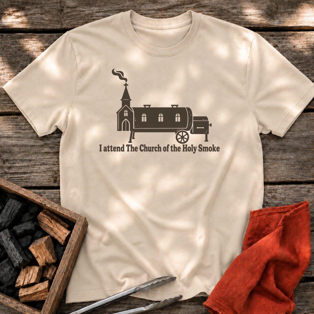 Sand T-shirt with the design “I attend The Church of the Holy Smoke” printed on the front.