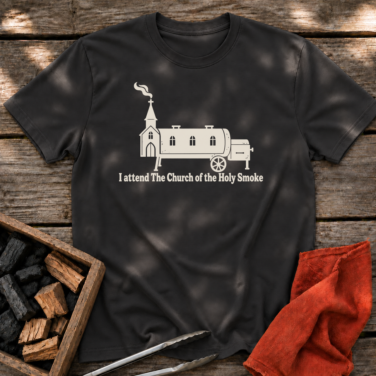 Black T-shirt with the design “I attend The Church of the Holy Smoke” printed on the front.