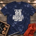 Navy T-shirt with the design “I've Got 99 Problems But My Brisket Ain't One” printed on the front.