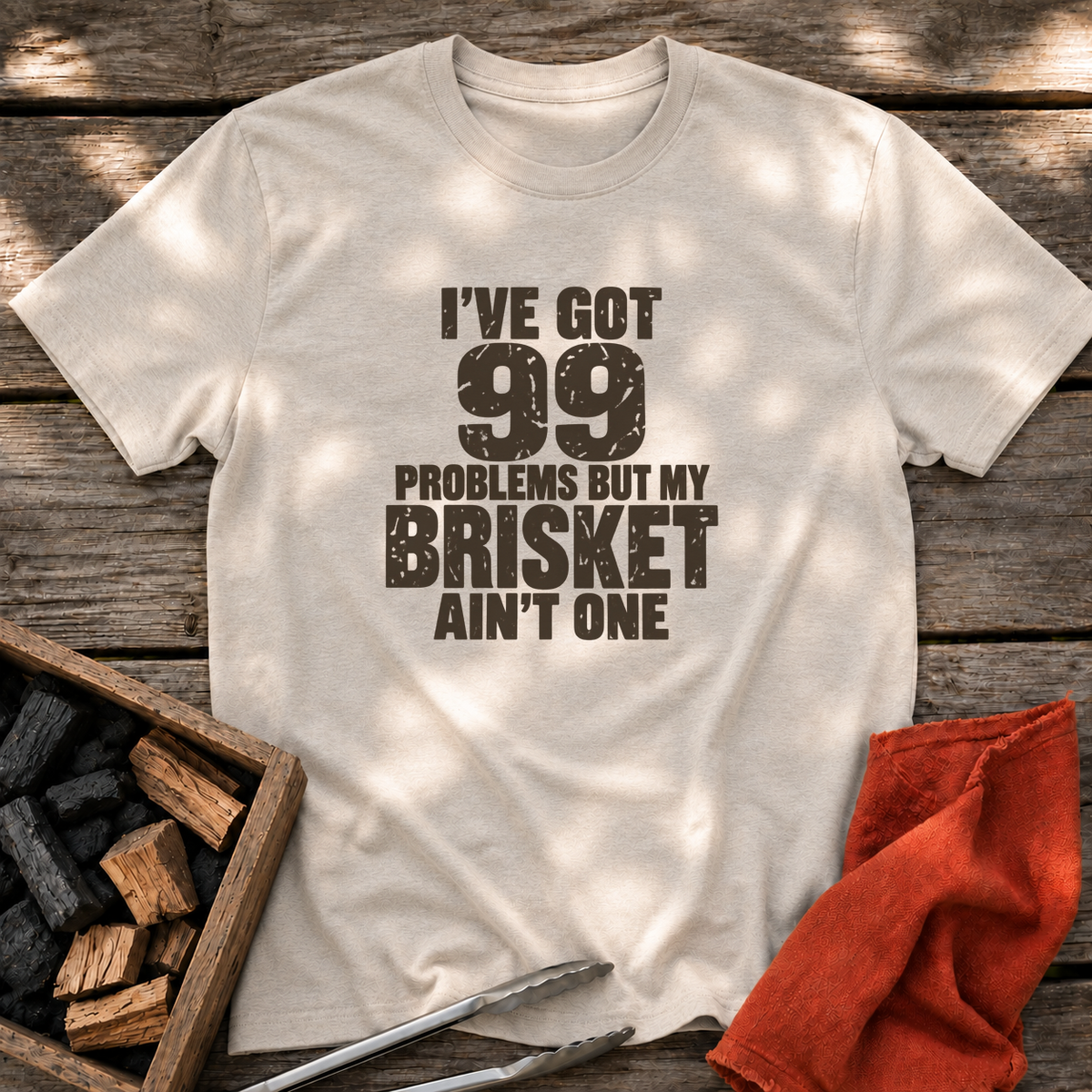 Natural T-shirt with the design “I've Got 99 Problems But My Brisket Ain't One” printed on the front.