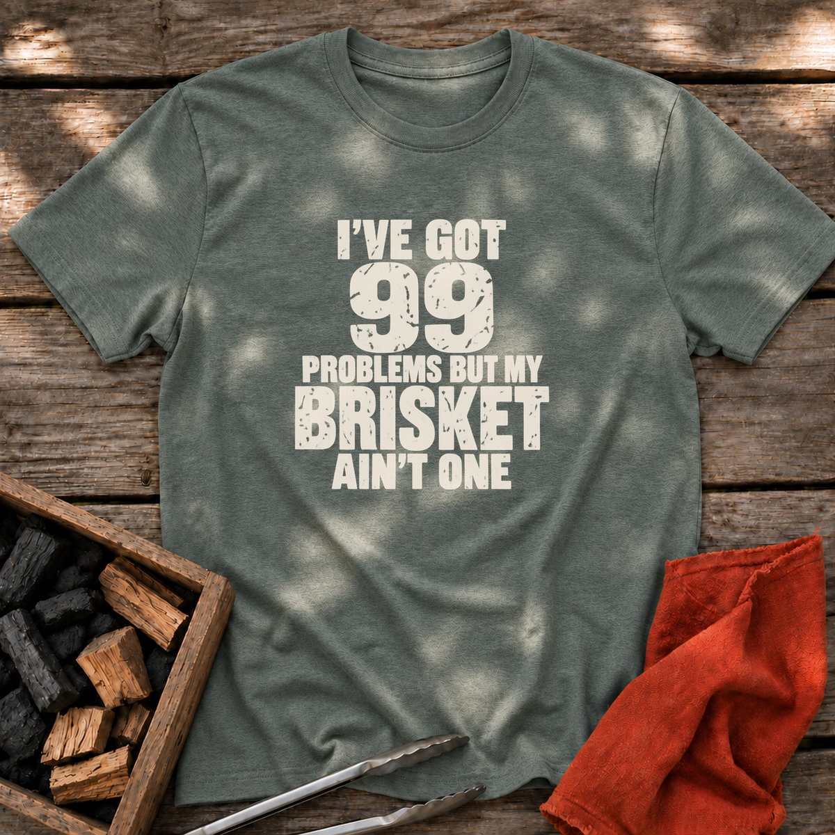 Heather Military Green T-shirt with the design “I've Got 99 Problems But My Brisket Ain't One” printed on the front.