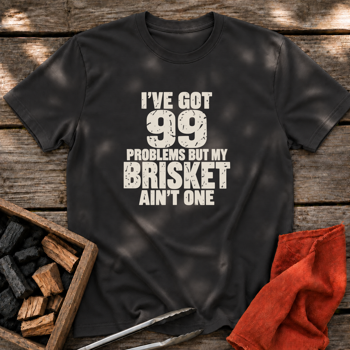 Black T-shirt with the design “I've Got 99 Problems But My Brisket Ain't One” printed on the front.