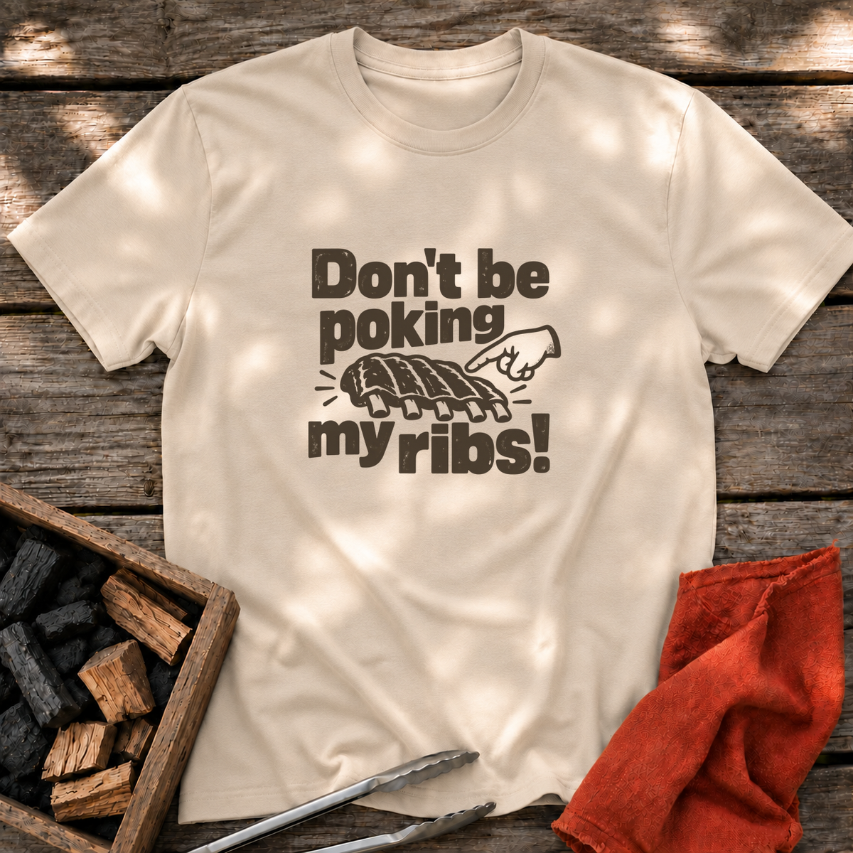 Sand T-shirt with the design “Don't be poking my ribs!” printed on the front.