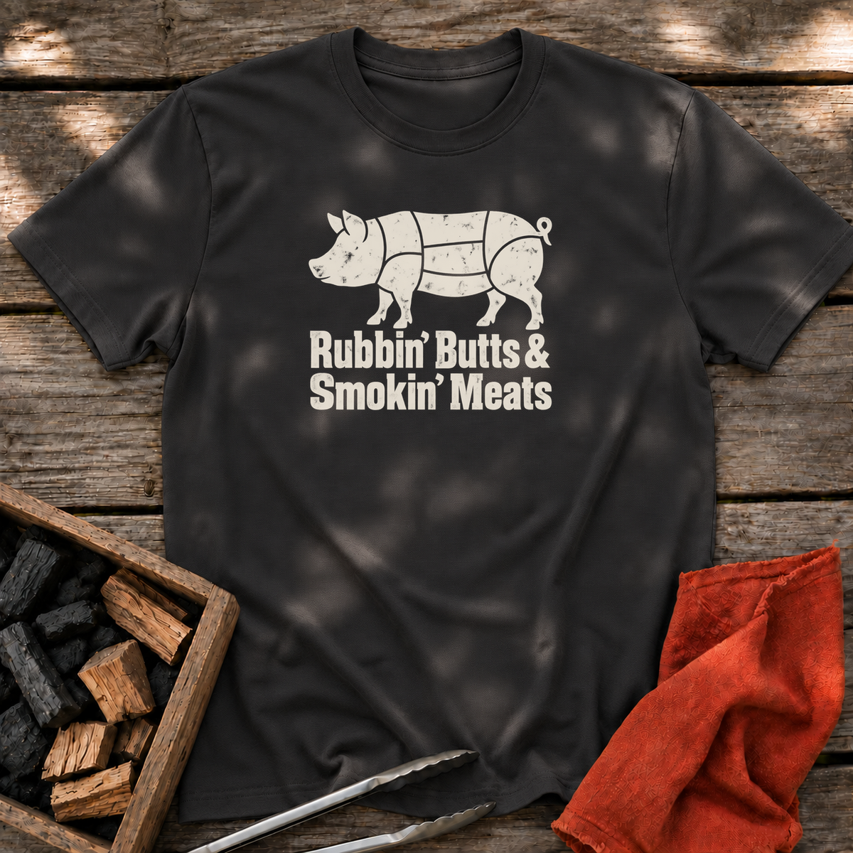 Black T-shirt with the design “Rubbin' Butts & Smokin' Meats” printed on the front.