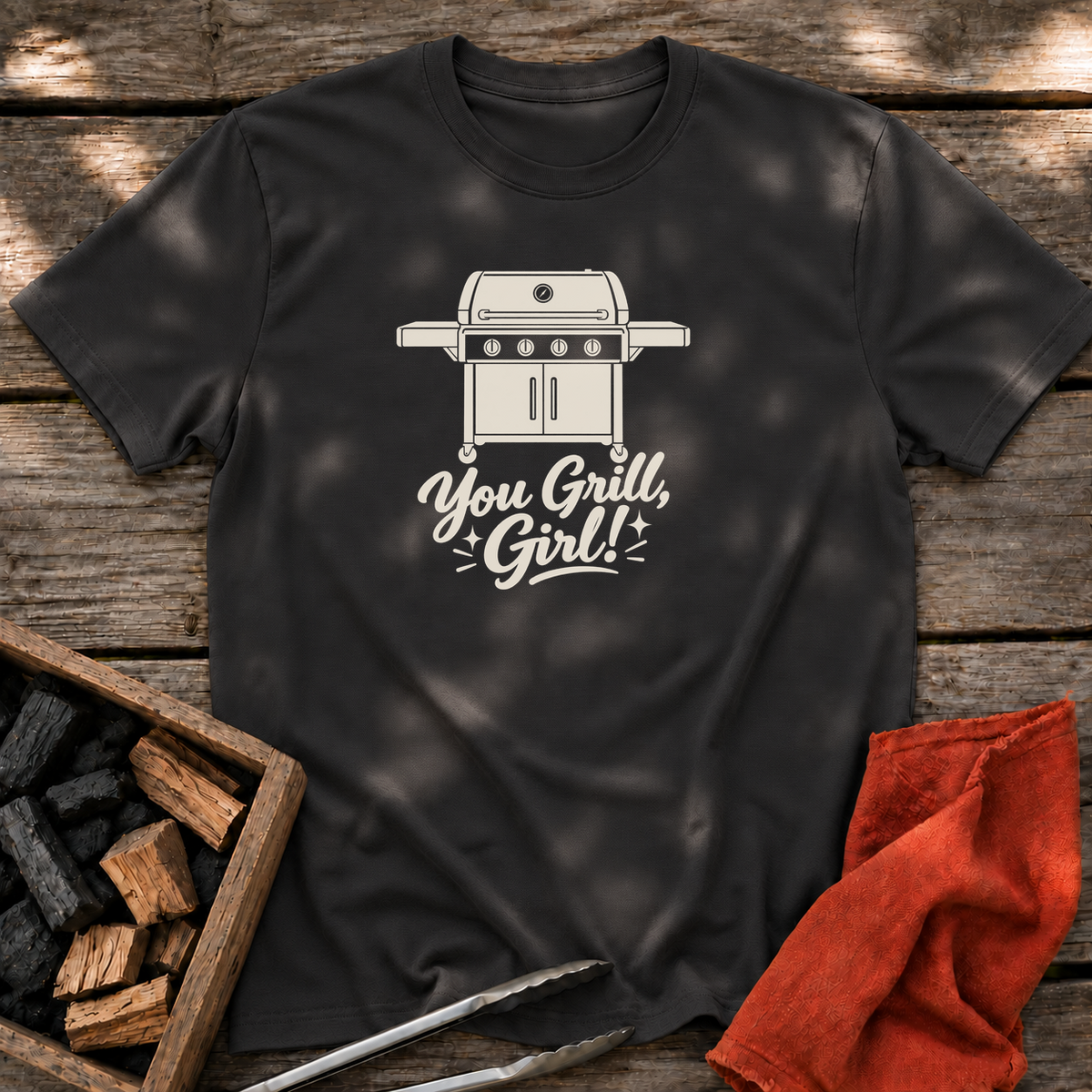 Black T-shirt with the design “You Grill, Girl!” printed on the front.