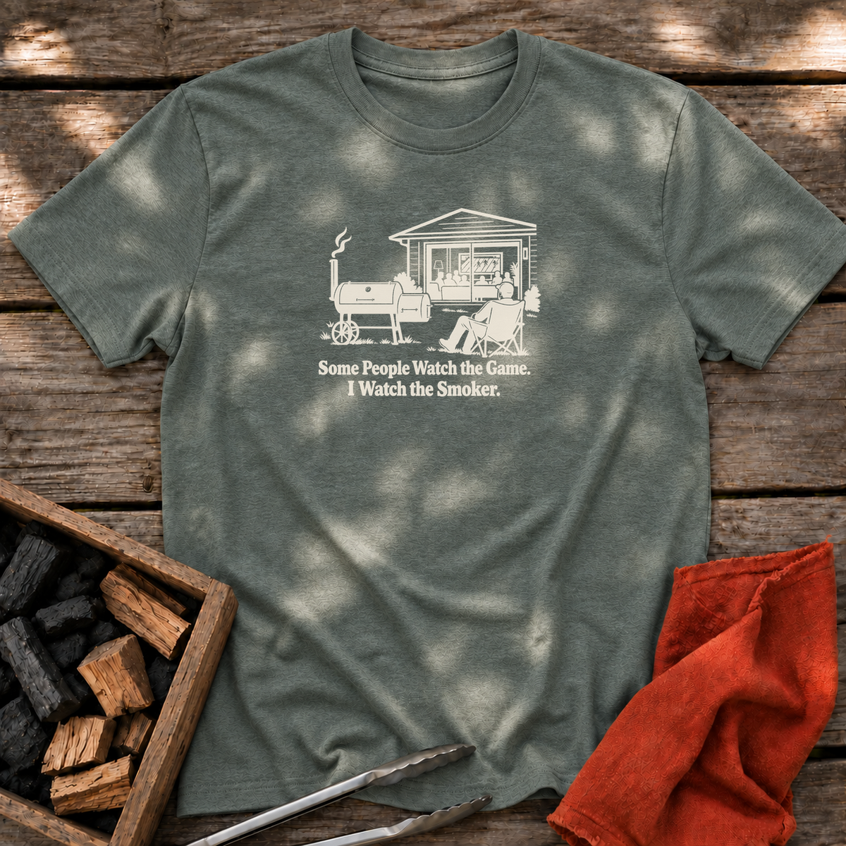 Heather Military Green T-shirt with the design “Some People Watch the Game. I Watch the Smoker.” printed on the front.