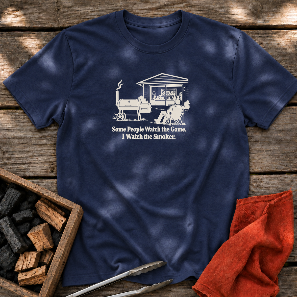 Navy T-shirt with the design “Some People Watch the Game. I Watch the Smoker.” printed on the front.