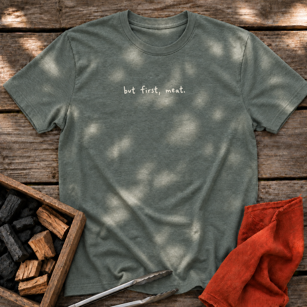 Heather Military Green T-shirt with the design “but first, meat.” printed on the front.