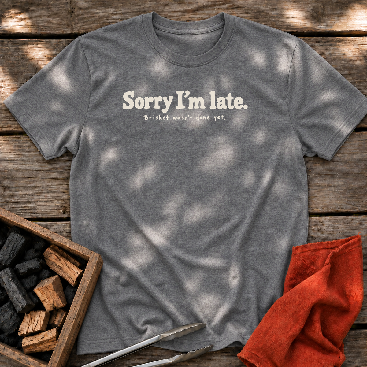 Graphite Heather T-shirt with the design “Sorry I’m late. Brisket wasn't done yet.” printed on the front.