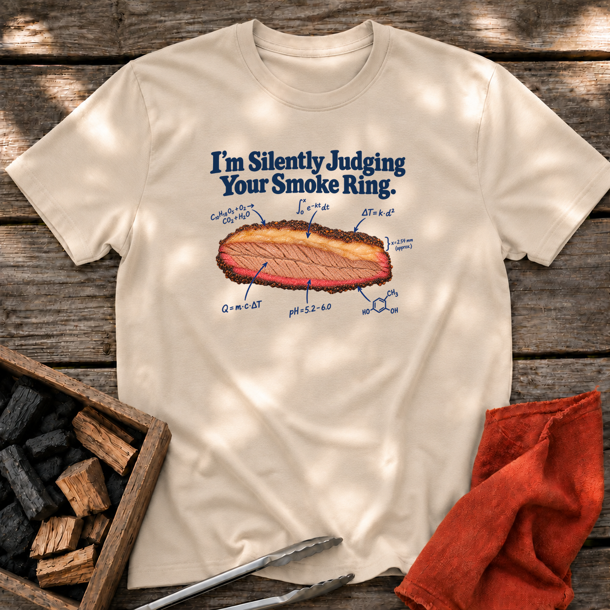 Sand T-shirt with the design “I’m Silently Judging Your Smoke Ring.” printed on the front.