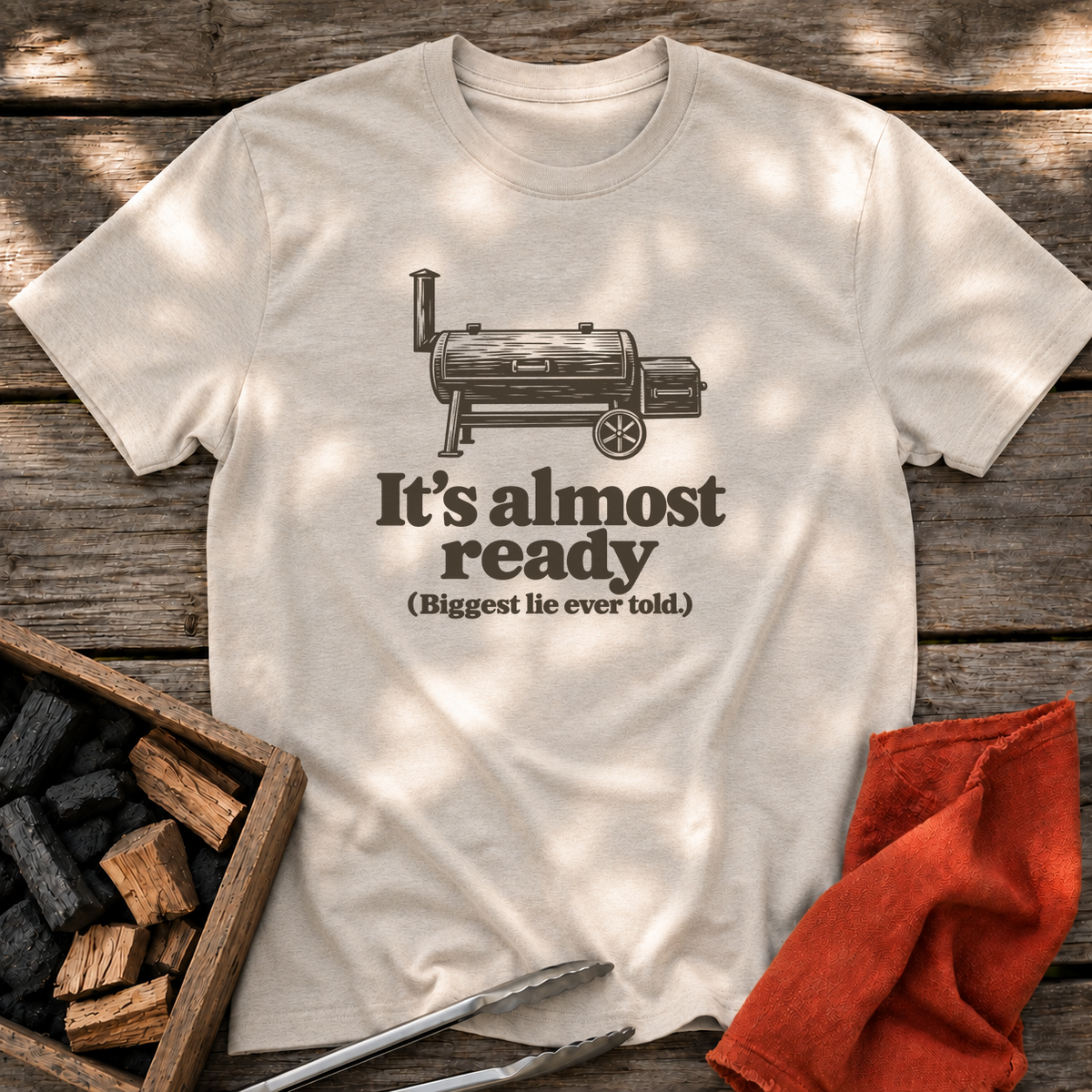 Natural T-shirt with the design “It's almost ready (Biggest lie ever told.)” printed on the front.
