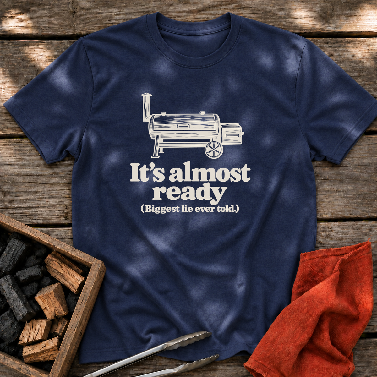 Navy T-shirt with the design “It's almost ready (Biggest lie ever told.)” printed on the front.