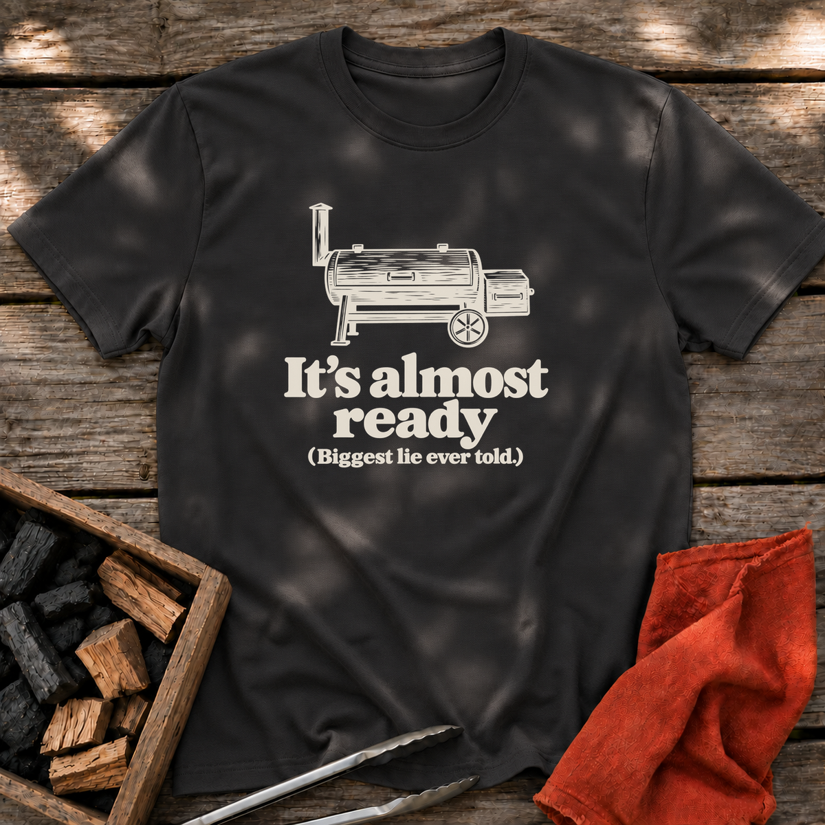 Black T-shirt with the design “It's almost ready (Biggest lie ever told.)” printed on the front.