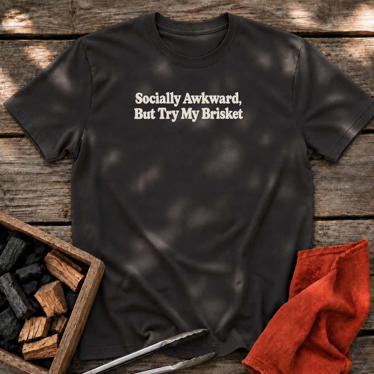 Black T-shirt with the design “Socially Awkward, But Try My Brisket” printed on the front.
