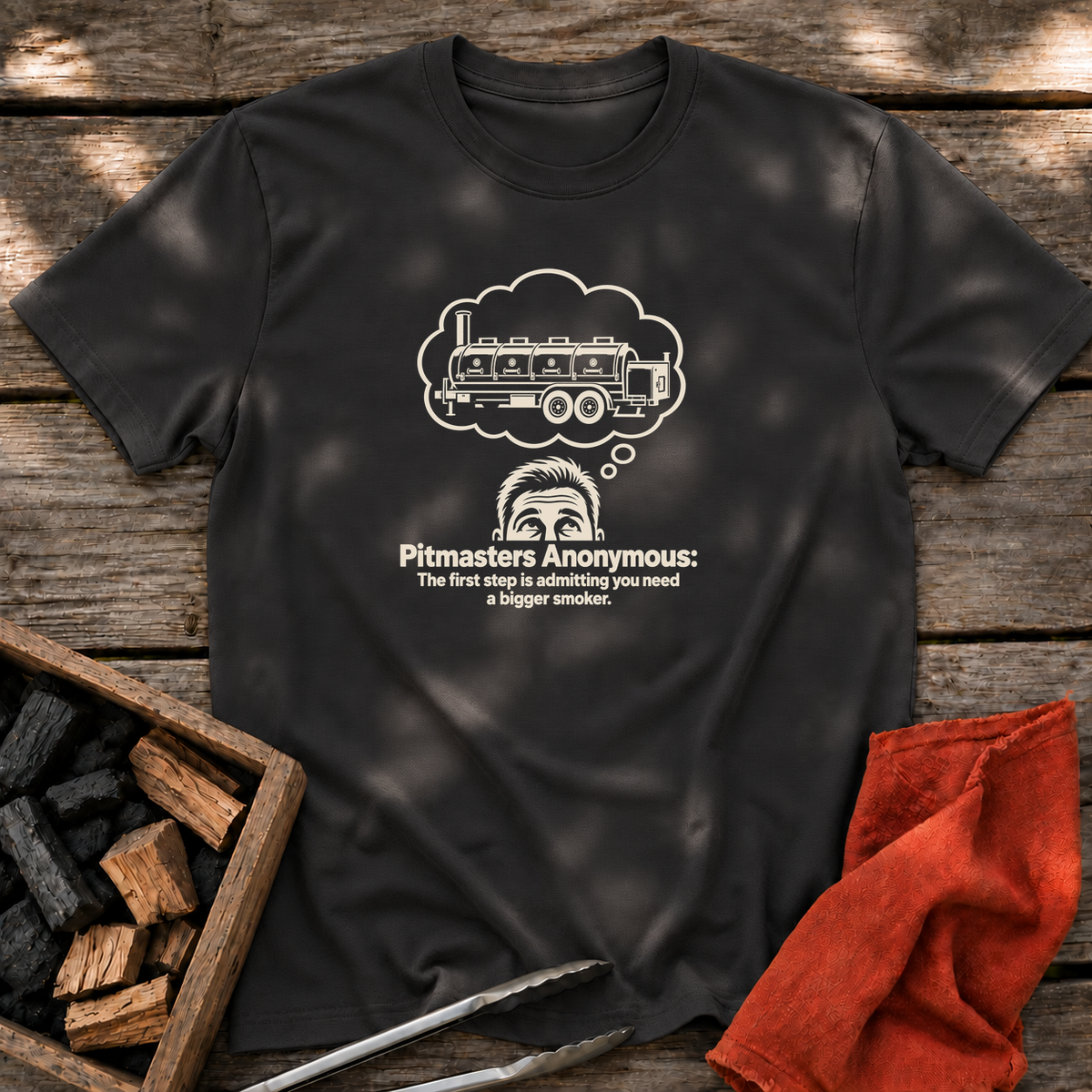 Black T-shirt with the design “Pitmasters Anonymous: The first step is admitting you need a bigger smoker.” printed on the front.