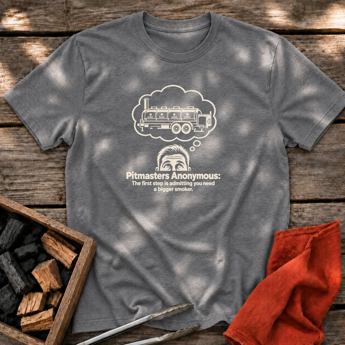 Graphite Heather T-shirt with the design “Pitmasters Anonymous: The first step is admitting you need a bigger smoker.” printed on the front.