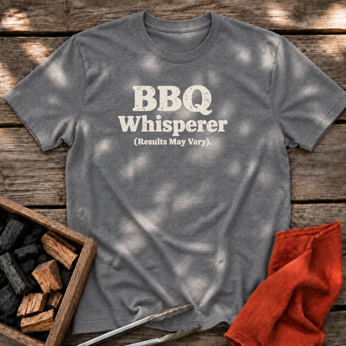 Graphite Heather T-shirt with the design “BBQ Whisperer (Results May Vary).” printed on the front.