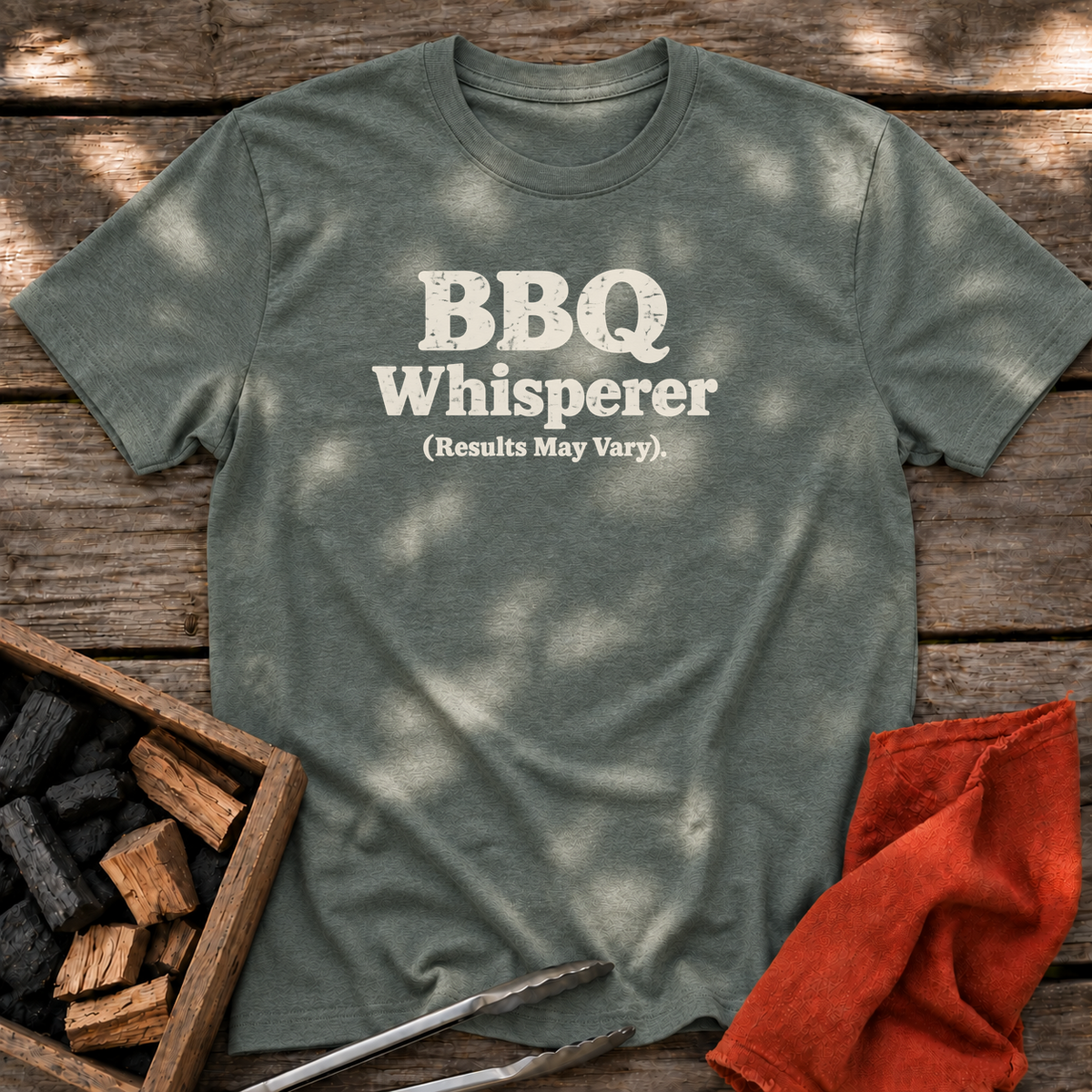 Heather Military Green T-shirt with the design “BBQ Whisperer (Results May Vary).” printed on the front.