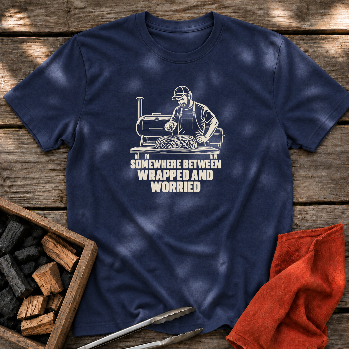 Navy T-shirt with the design “SOMEWHERE BETWEEN WRAPPED AND WORRIED” printed on the front.