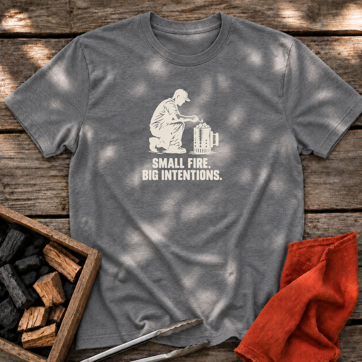 Graphite Heather T-shirt with the design “SMALL FIRE. BIG INTENTIONS.” printed on the front.