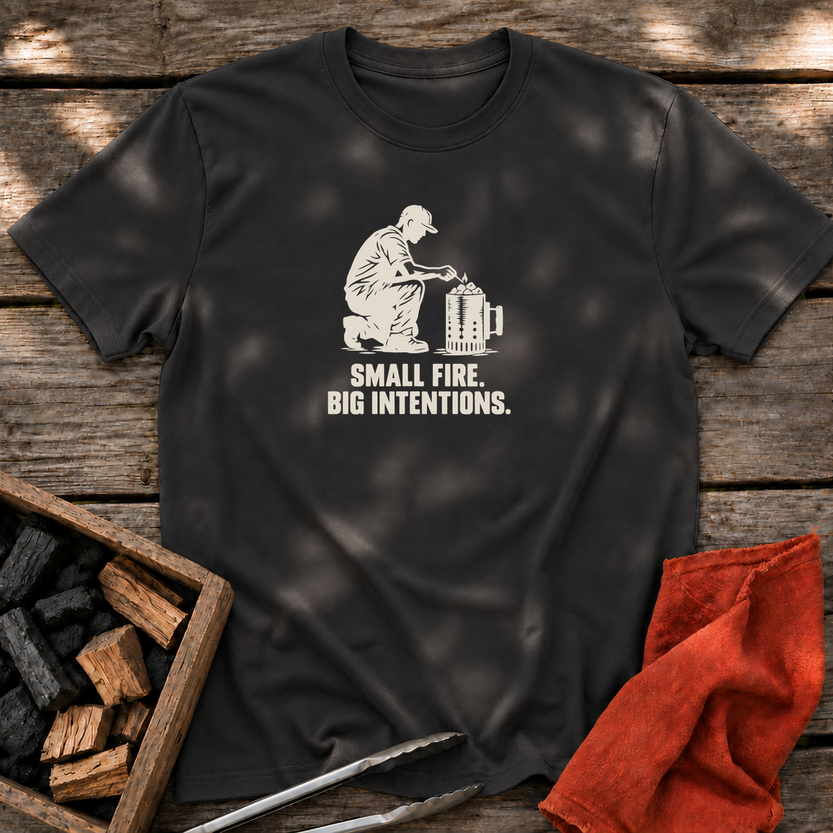 Black T-shirt with the design “SMALL FIRE. BIG INTENTIONS.” printed on the front.