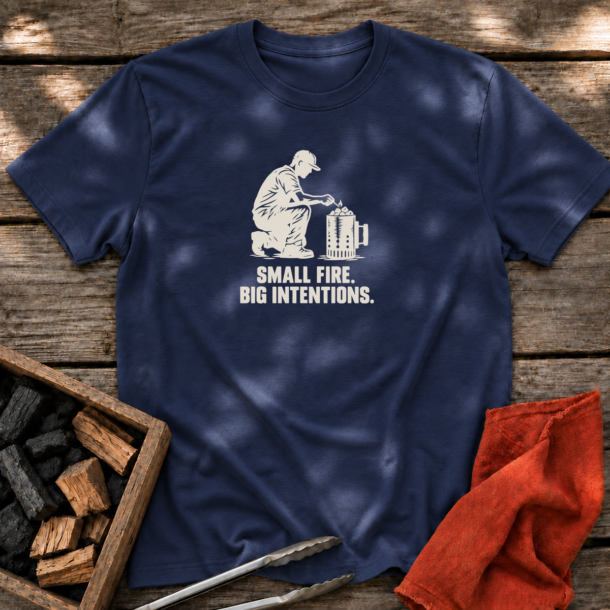 Navy T-shirt with the design “SMALL FIRE. BIG INTENTIONS.” printed on the front.