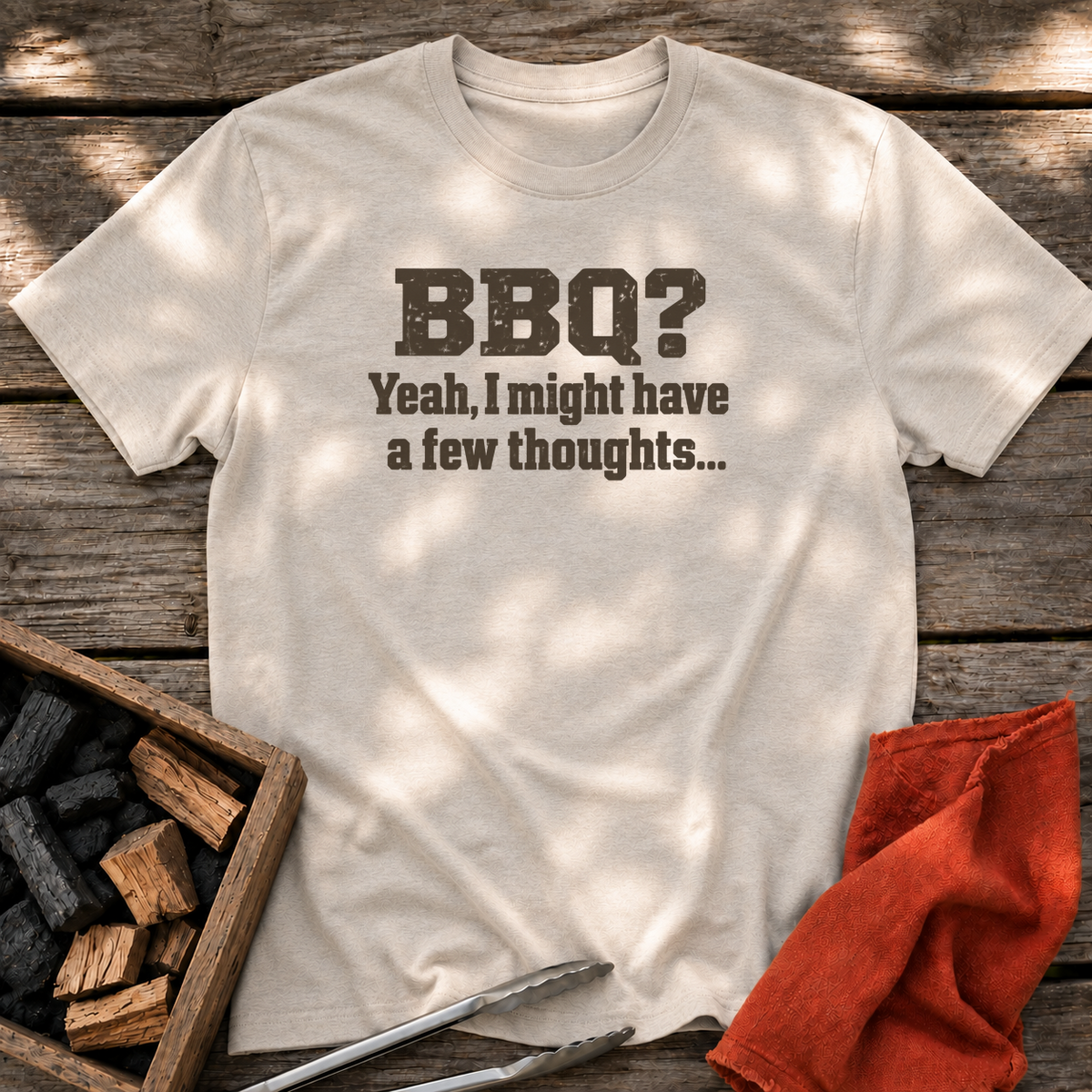 Natural T-shirt with the design “BBQ? Yeah, I might have a few thoughts…” printed on the front.