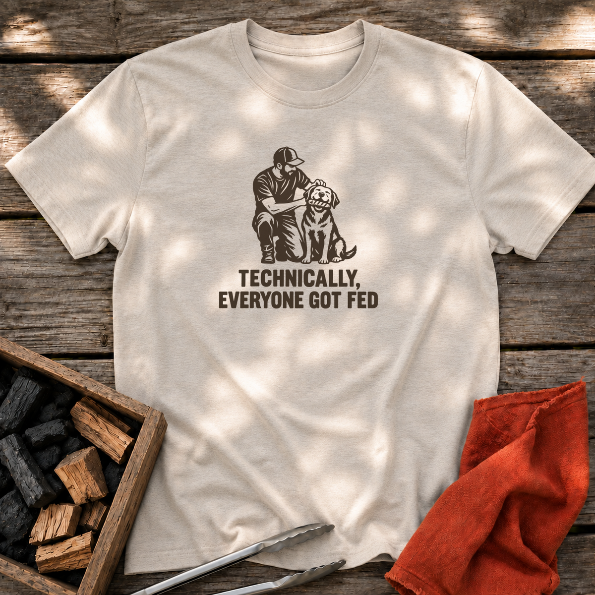 Natural T-shirt with the design “TECHNICALLY, EVERYONE GOT FED” printed on the front.