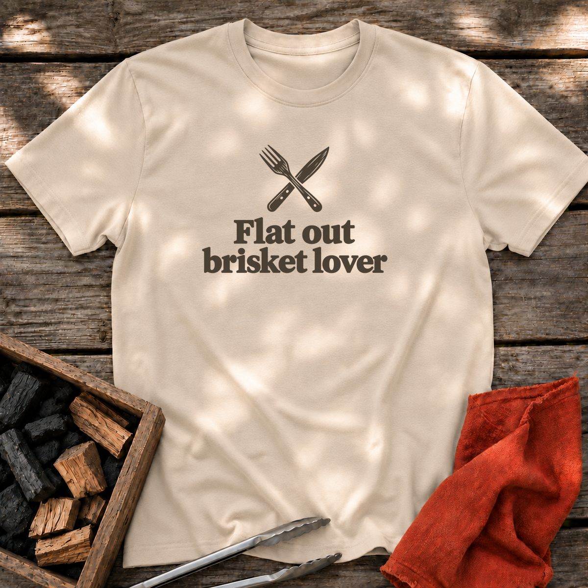 Sand T-shirt with the design “Flat out brisket lover” printed on the front.