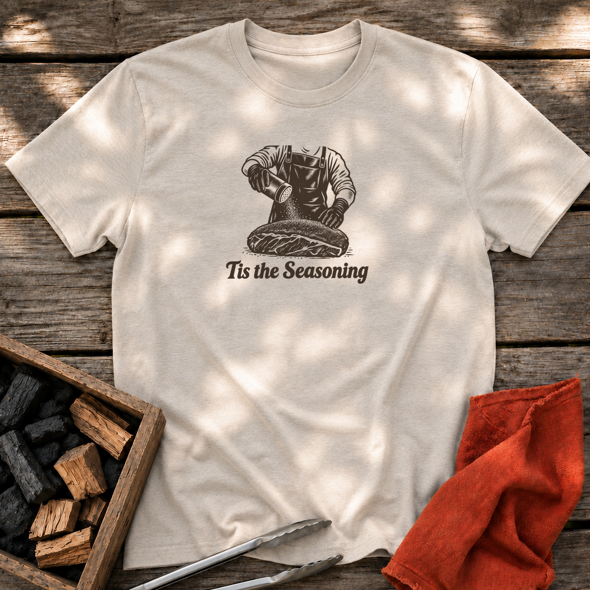 Natural T-shirt with the design “Tis the Seasoning” printed on the front.