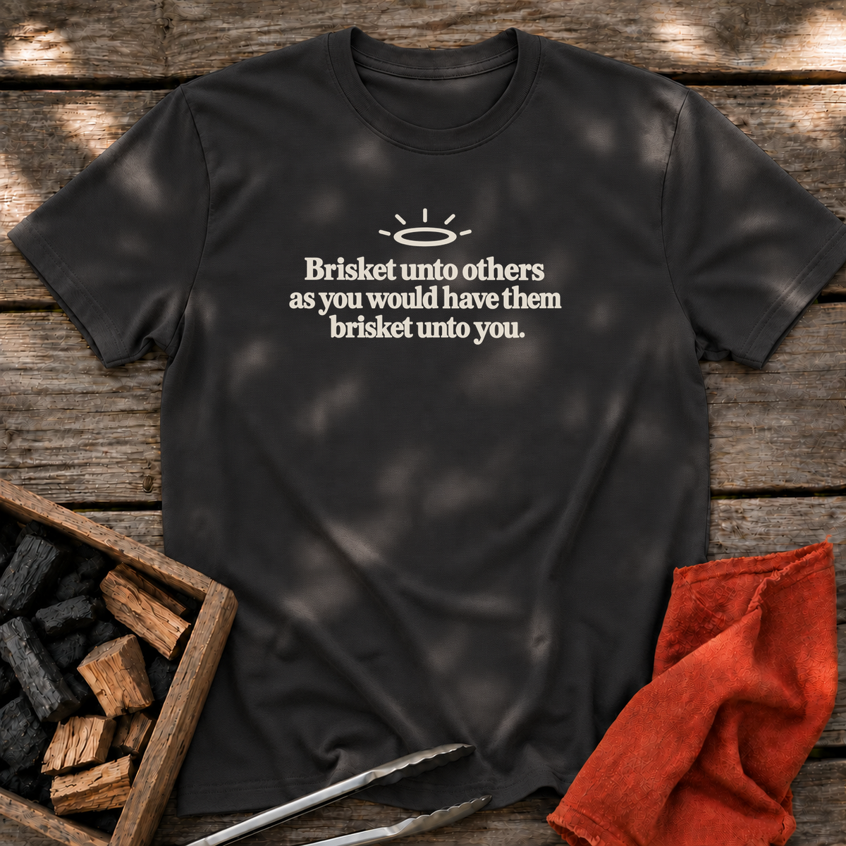 Black T-shirt with the design “Brisket unto others as you would have them brisket unto you.” printed on the front.