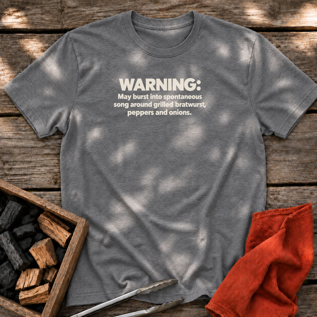 Graphite Heather T-shirt with the design “WARNING: May burst into spontaneous song around grilled bratwurst, peppers and onions.” printed on the front.
