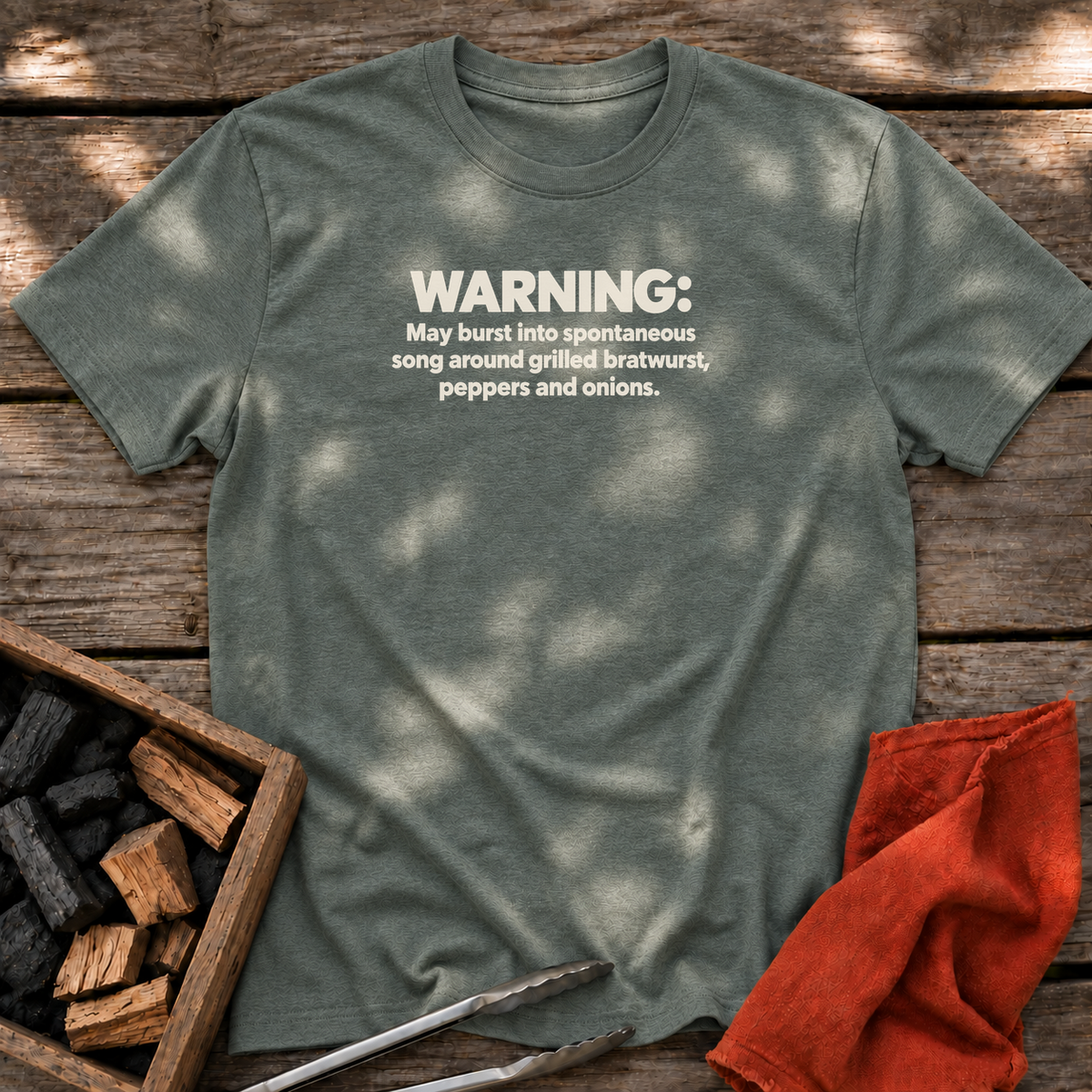 Heather Military Green T-shirt with the design “WARNING: May burst into spontaneous song around grilled bratwurst, peppers and onions.” printed on the front.