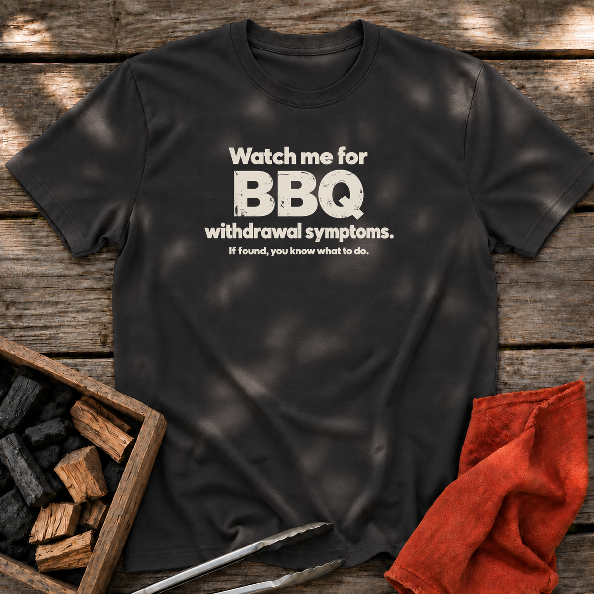 Black T-shirt with the design “Watch me for BBQ withdrawal symptoms. If found, you know what to do.” printed on the front.
