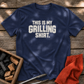 Navy T-shirt with the design “This is My Grilling Shirt.” printed on the front.